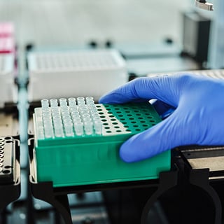 Hand van medewerker laboratorium Hartwig die de robot installeert